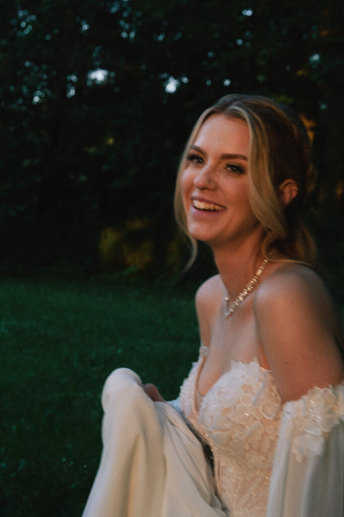 Ujęcie panny młodej na sesji ślubnej, naturalne światło, romantyczny klimat, elegancka suknia, styl glamour, fotografie plenerowe w naturalnym otoczeniu.