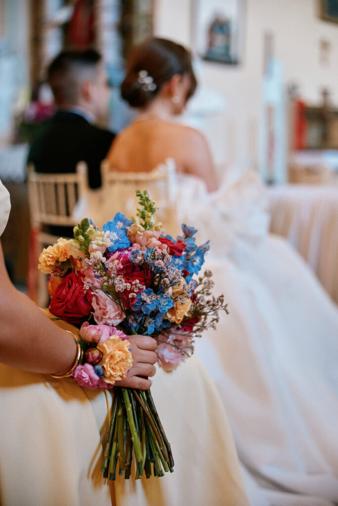 Antyczny bukiet ślubny z róż i błękitnych kwiatów na tle pary młodej (ślub, dekoracje, bouquet).